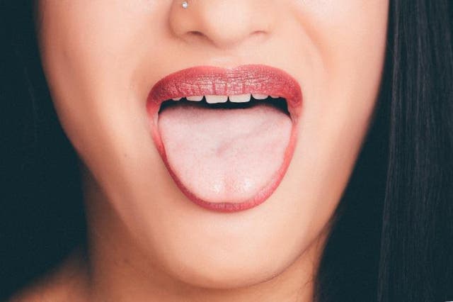<p>Image includes woman sticking tongue out</p>