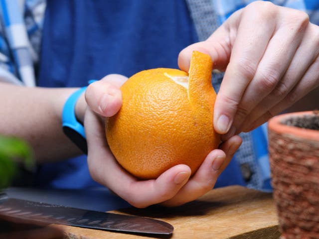<p>Someone peeling an orange</p>