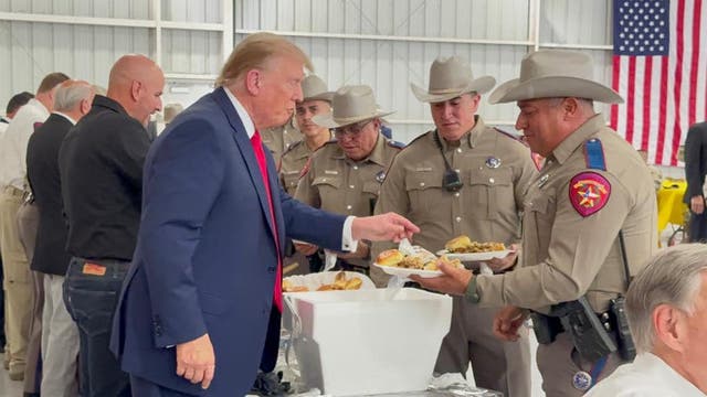 <p>Former President Donald Trump hands out Thanksgiving meals to officers working at the Southern Border as part of Operation Lone Star</p>